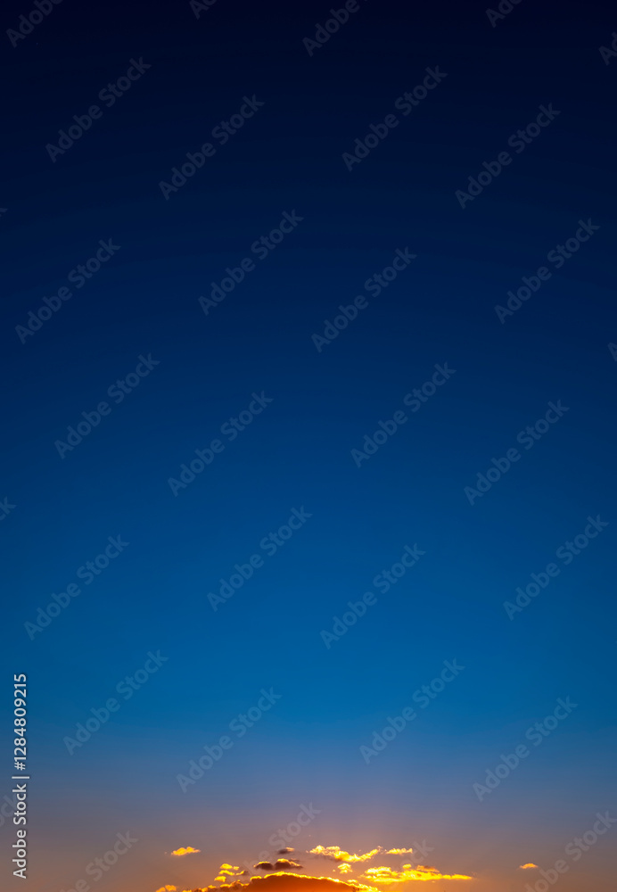 Obraz premium Sky clouds sunset natural background. Stunning view of golden clouds and gradient blue sky