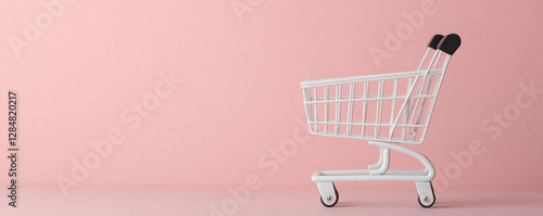 E-commerce growth and online business. Shopping cart against a pink background. photo