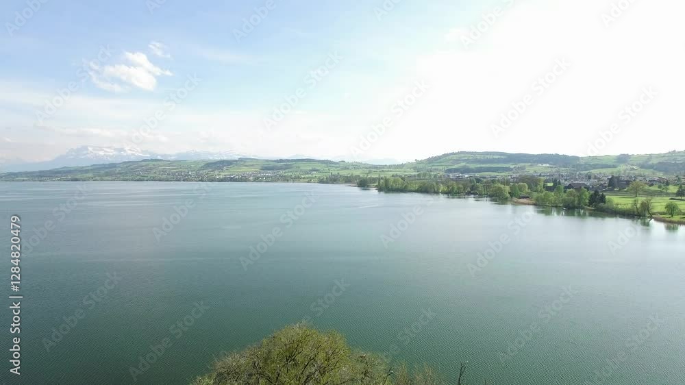 Serene Lake Landscape Featuring Lush Greenery Set Amongst Majestic Mountains Nearby Serene Lake Landscape Featuring Lush Greenery Set Amongst Majestic Mountains Nearby