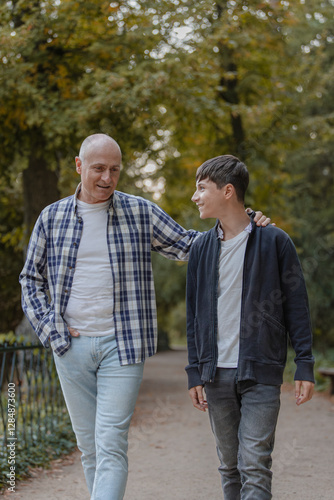 Father and son walking in the field, talking