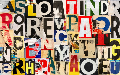 Collage of many different lacerated letters ripped torn advertisement street posters grunge creased crumpled paper texture background placard backdrop surface
