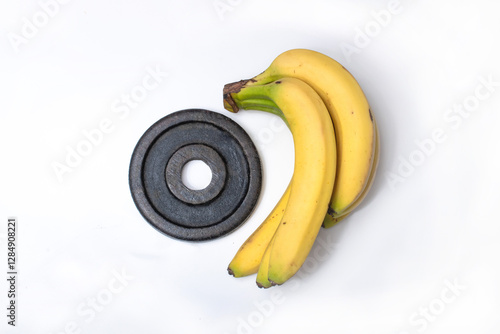 Dumbbells and a banana, symbolizing the balance between fitness training and healthy nutrition for a well-rounded fitness lifestyle.