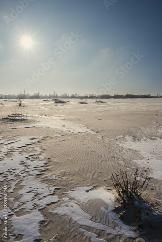 Sand quarry in th Vilnohirsk , Ukraine. Winter landscape on the sand quarry ,sun rays on the sy , beautiful colors on the picture . Path on the sand . Road and trees with lights of the sun . Trees  photo