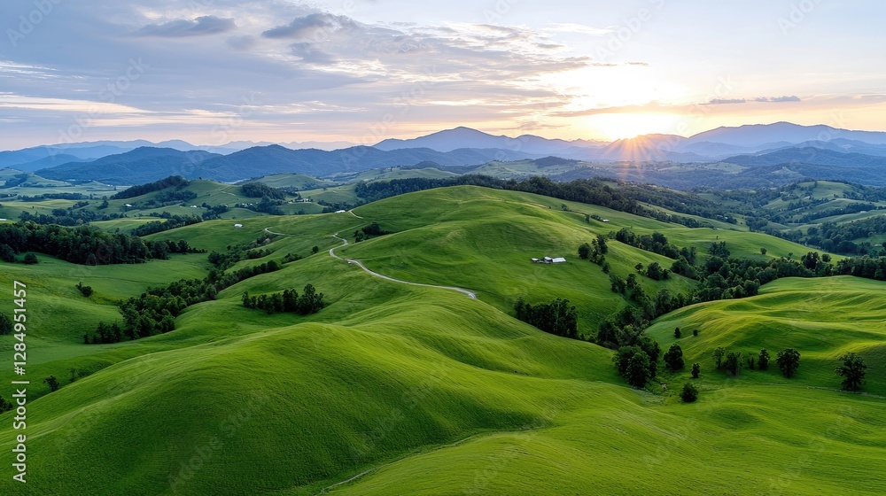 Obraz premium Sunset over rolling green hills, rural landscape, idyllic scenery
