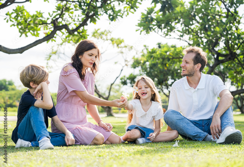 Happy family parent children having picnic outdoor activity. Enjoy happiness moment summer playing together including father mother son and daughter relaxing in the morning sunrise. Happy family parent children having picnic outdoor activity. Enjoy happiness moment summer playing together including father mother son and daughter relaxing in the morning sunrise.
