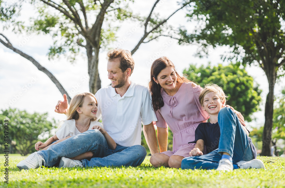 Fototapeta premium Happy family parent children having picnic outdoor activity. Enjoy happiness moment summer playing together including father mother son and daughter relaxing in the morning sunrise.