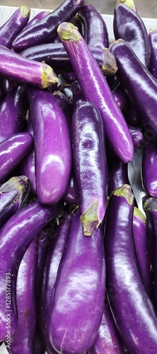 Fresh Purple Eggplants Stacked in a Pile – Organic and Vibrant Vegetables
 photo