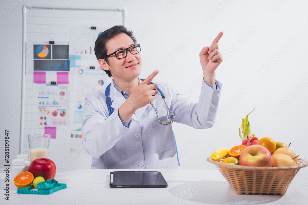 A male nutritionist works at his desk, discussing the benefits of eating fruit. He analyzes diets and educates patients on healthy eating habits for optimal health and well-being A male nutritionist works at his desk, discussing the benefits of eating fruit. He analyzes diets and educates patients on healthy eating habits for optimal health and well-being