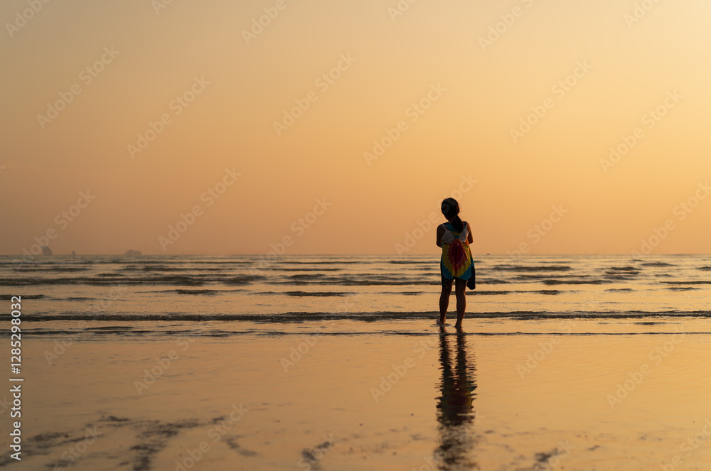 back asian child or kid girl standing on calm sea beach alone in summer island and people lonely relax with golden sunlight in evening sunset or morning sunrise with tourist on vacation travel holiday back asian child or kid girl standing on calm sea beach alone in summer island and people lonely relax with golden sunlight in evening sunset or morning sunrise with tourist on vacation travel holiday
