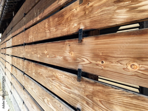 Details of exterior wooden screen for snow protection.