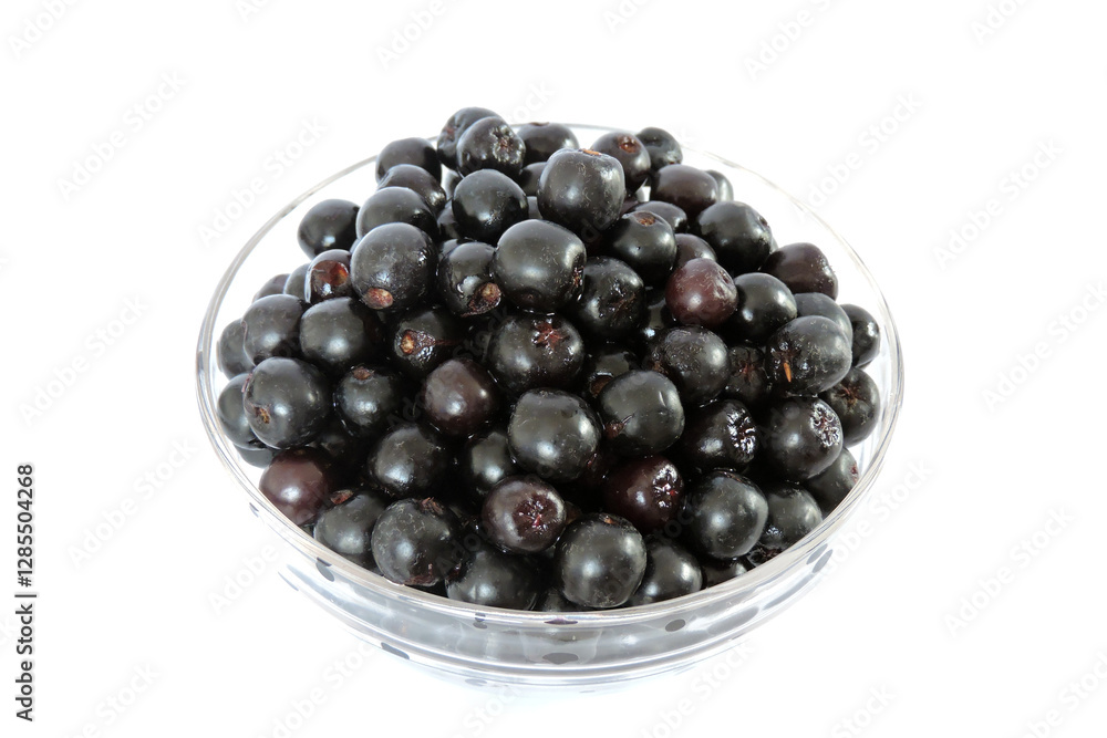 Fresh ripe aronia berries in a glass bowl, white background, isometric view Fresh ripe aronia berries in a glass bowl, white background, isometric view