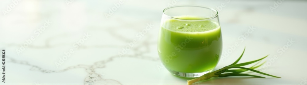 Glass of green juice on a table Glass of green juice on a table