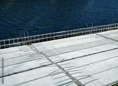 Construction of a modern pedestrian embankment on a large lake photo