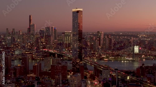 Wallpaper Mural Golden evening light baths Two Bridges district in Manhattan, New York City, casting reflections on towering skyscrapers, radiating metropolitan vibrancy Torontodigital.ca