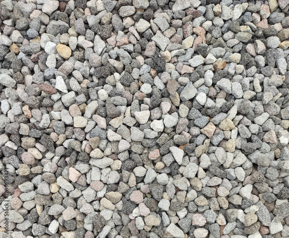 Texture of grey color of the crushed granite and limestone coarse gravel foreground closeup Texture of grey color of the crushed granite and limestone coarse gravel foreground closeup