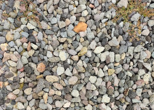 Texture of grey color of the crushed granite and limestone coarse gravel foreground closeup photo