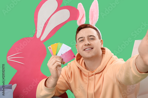 Young man in bunny ears wit...