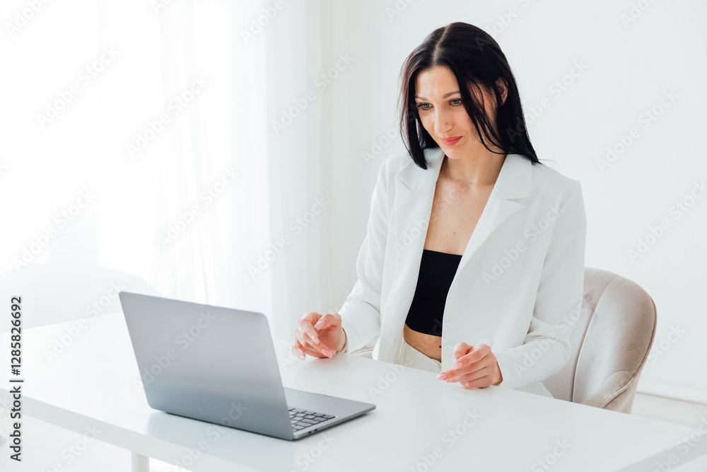 Brunette Woman In White Business Suit With Laptop Online In Office At Training Brunette Woman In White Business Suit With Laptop Online In Office At Training