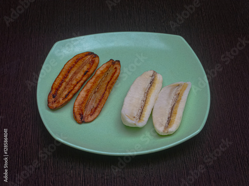 Fried and unfried bananas are on the dinner plate photo