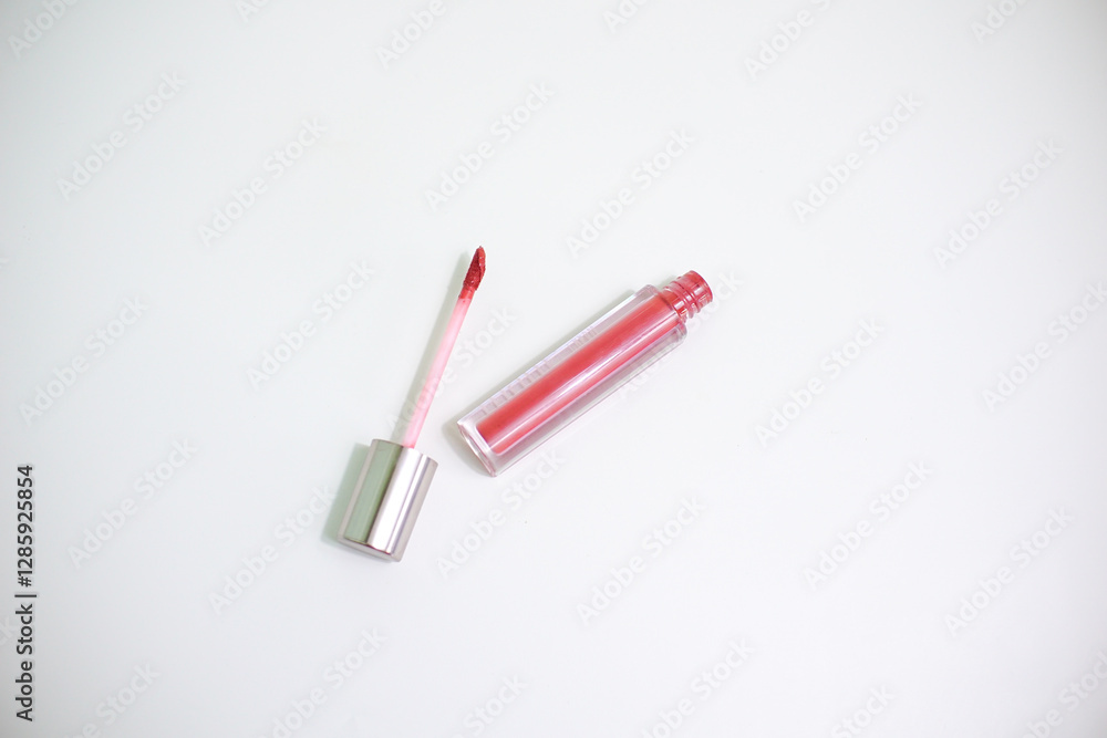 Red lip gloss in elegant glass bottle with shiny lid, container with brush isolated on white background, red lipstick Red lip gloss in elegant glass bottle with shiny lid, container with brush isolated on white background, red lipstick