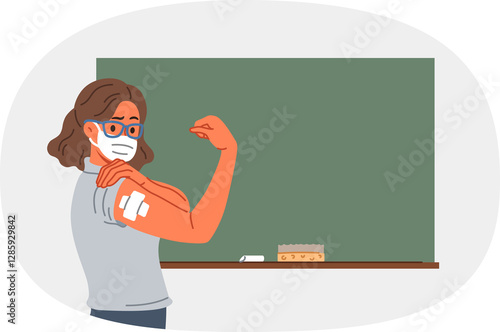 Obraz na płótnie Vaccinated female teacher demonstrates patch at injection site on arm, standing near school board. Vaccinated girl teacher recommends taking preventive measures to protect against virus w salonie