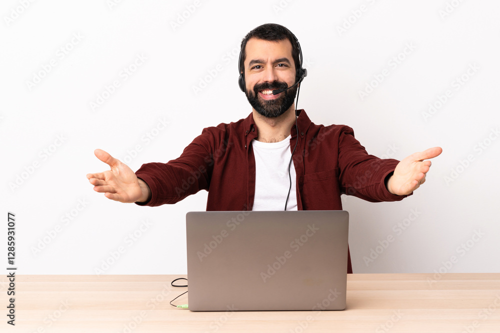 Telemarketer caucasian man working with a headset and with laptop presenting and inviting to come with hand. Telemarketer caucasian man working with a headset and with laptop presenting and inviting to come with hand.