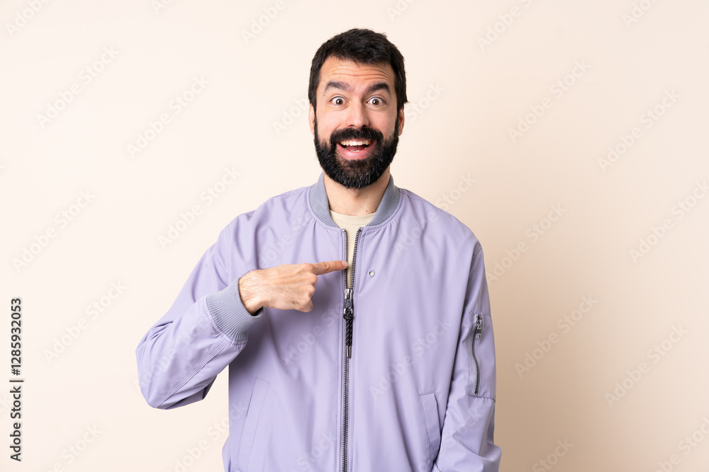 Caucasian man with beard wearing a jacket over isolated background with surprise facial expression Caucasian man with beard wearing a jacket over isolated background with surprise facial expression
