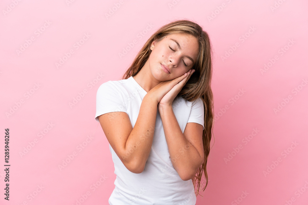 Little caucasian girl isolated on pink background making sleep gesture in dorable expression Little caucasian girl isolated on pink background making sleep gesture in dorable expression