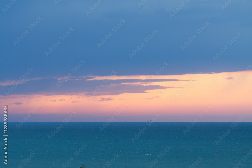 Fototapeta premium blue sea and pink sky during a storm, stormy sea, blue sea, purple sky, azure blue, high waves, splashing waves