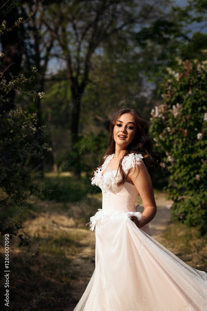 Stunning bride gracefully poses in a spring park, among blossoming trees. exuding elegance, Stunning bride gracefully poses in a spring park, among blossoming trees. exuding elegance,