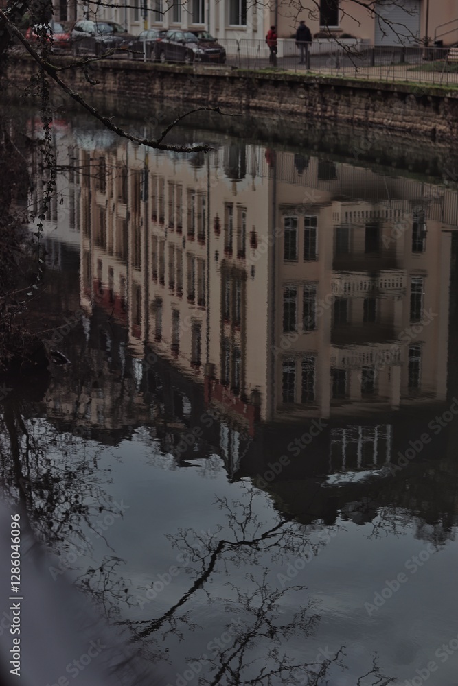 A stunning view of a historic building in the heart of the city, perfectly mirrored in the calm waters of the canal. The reflection on the water enhances the timeless beauty of the structure, evoking A stunning view of a historic building in the heart of the city, perfectly mirrored in the calm waters of the canal. The reflection on the water enhances the timeless beauty of the structure, evoking