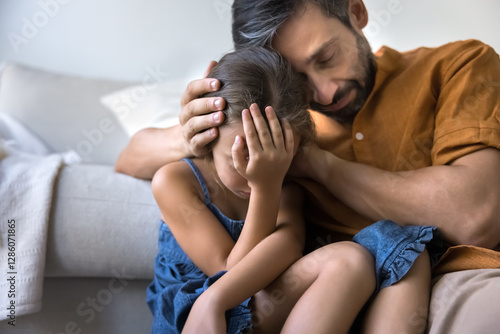 Tableau sur toile Close up of caring dad comforting his little daughter, coping with hard period of life, gently embracing and consoles her