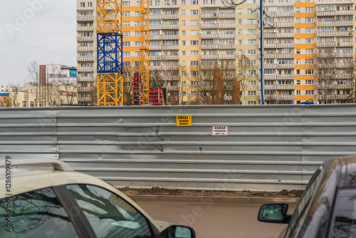 the construction site is fenced with a tin fence