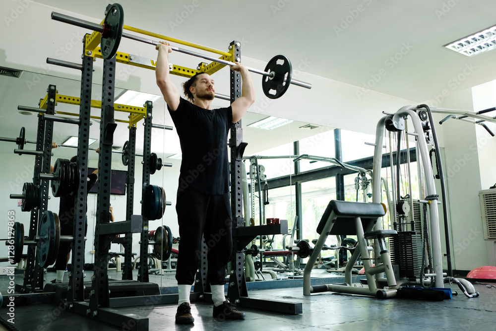Fototapeta premium Young man exercising for health in a fitness gym.