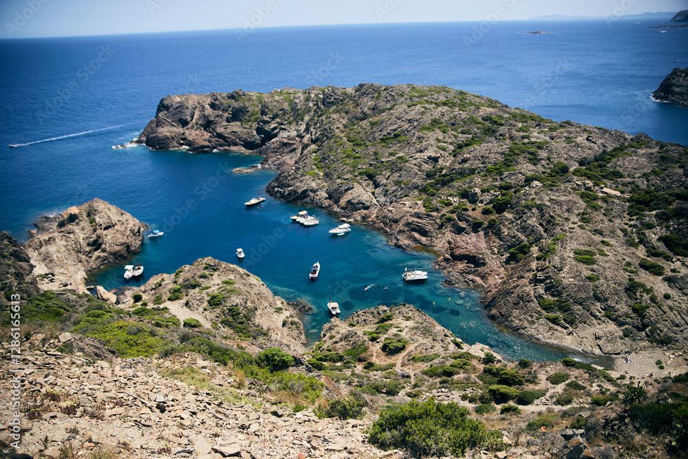 Aerial view of a rocky Mediterranean cove with boats anchored in turquoise waters Aerial view of a rocky Mediterranean cove with boats anchored in turquoise waters