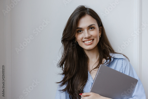 Portrait of a business girl with laptop on white background.