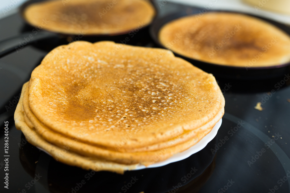 stack of appetizing flour pancakes in the kitchen during cooking stack of appetizing flour pancakes in the kitchen during cooking