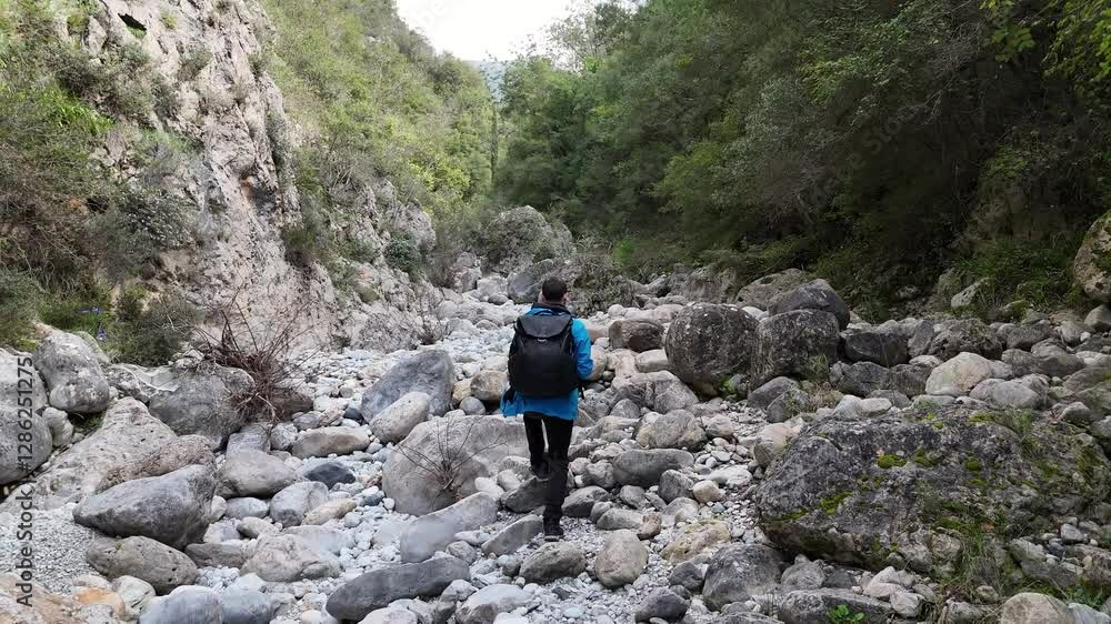 Aerial shot of tourists walking through Vyros Gorge near Kardamyli, Greece Aerial shot of tourists walking through Vyros Gorge near Kardamyli, Greece