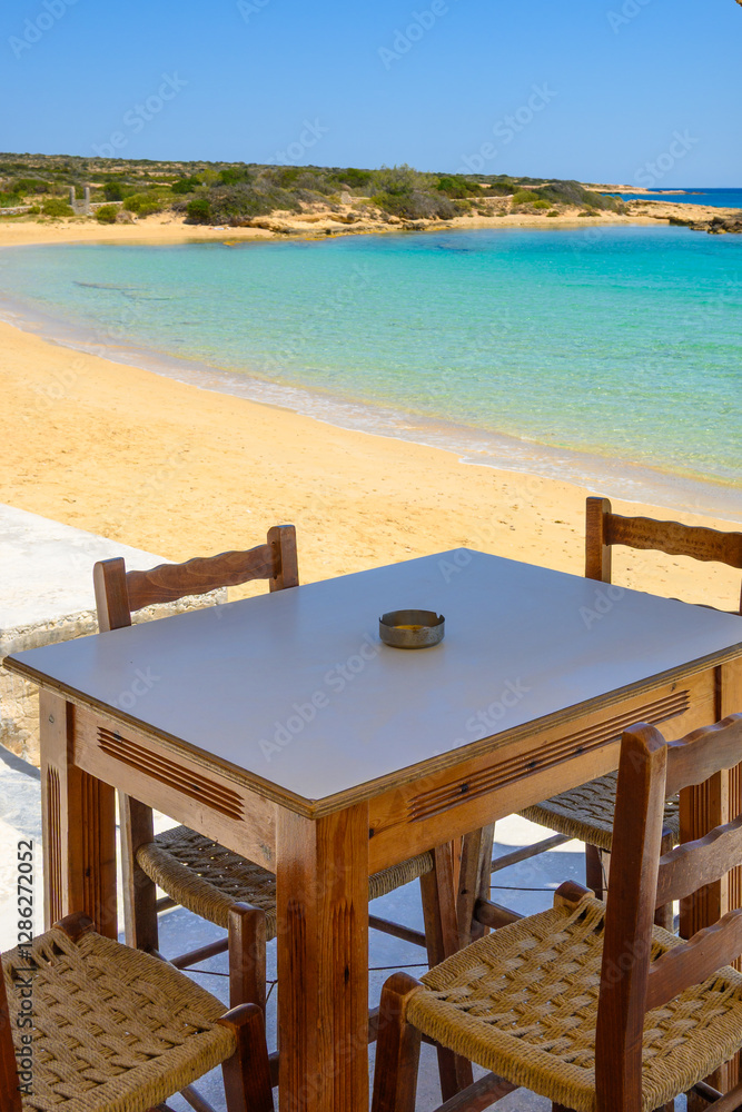 A table with chairs overlooking Finikas beach on Ano Koufonisi island