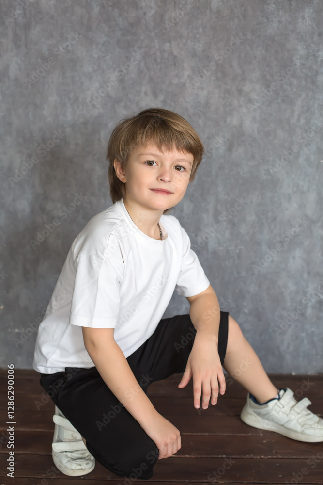 A handsome blond boy with big brown eyes wearing a white T-shirt A handsome blond boy with big brown eyes wearing a white T-shirt