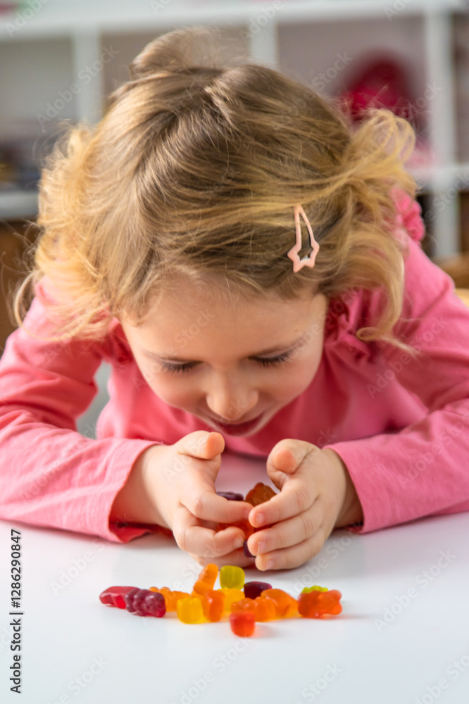 Child eating jelly candies at home. Selective focus. Child eating jelly candies at home. Selective focus.