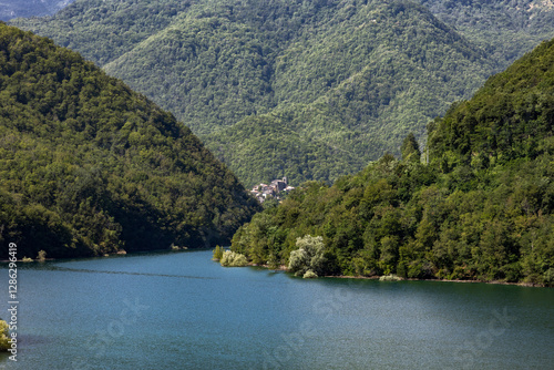 Lake Vagli conceals the submerged village of Fabbriche di Careggine in Tuscany Italy offering a mysterious underwater heritage amid mountains picturesque hillside views and hidden cultural history photo