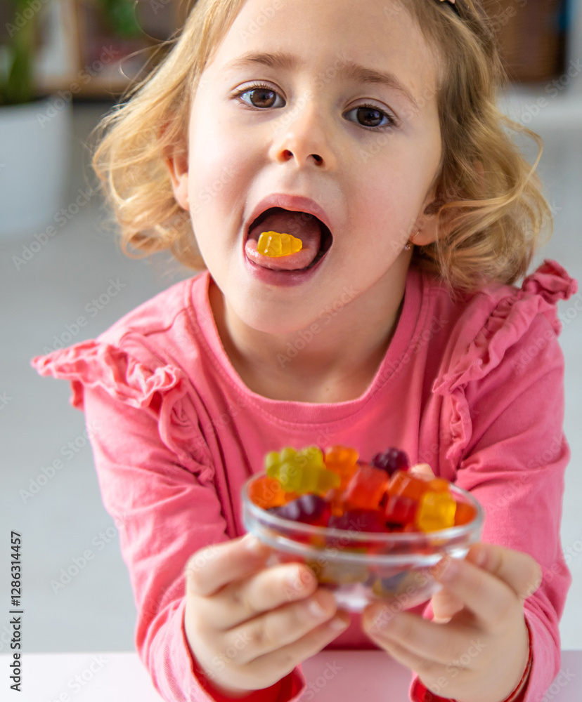 Child eating jelly candies at home. Selective focus. Child eating jelly candies at home. Selective focus.