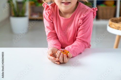 Child eating jelly candies at home. Selective focus.