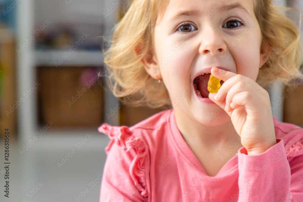 Child eating jelly candies at home. Selective focus. Child eating jelly candies at home. Selective focus.