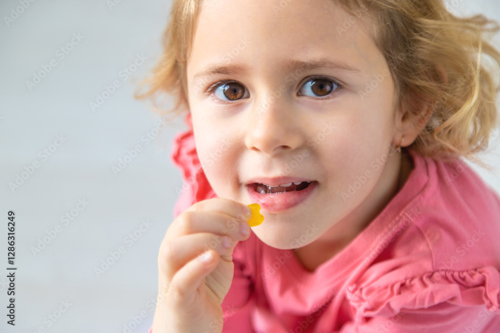 Child eating jelly candies at home. Selective focus.