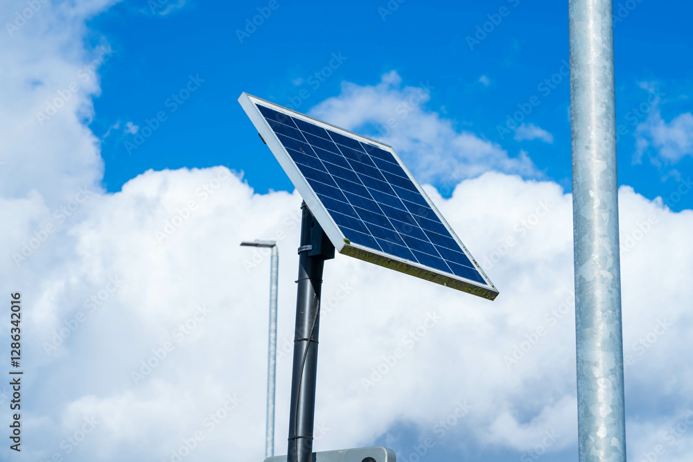 Obraz premium Single solar panel to power a street light, Solar panel cells powering a light pole