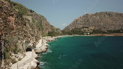 Breathtaking coastal walk along rocky cliffs with clear blue waters in scenic landscape