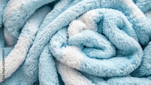 A detailed close-up view showcasing a vibrant pile of neatly folded blue and white towels, highlighting their soft texture and appealing colors.