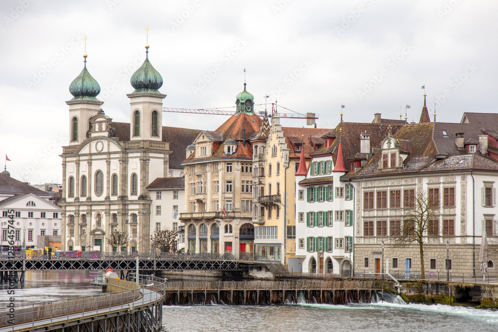 Naklejka premium Switzerland, Lucerne. Old city, Altstadt. Jesuit Church and other historic buildings on the banks of Reuss River.